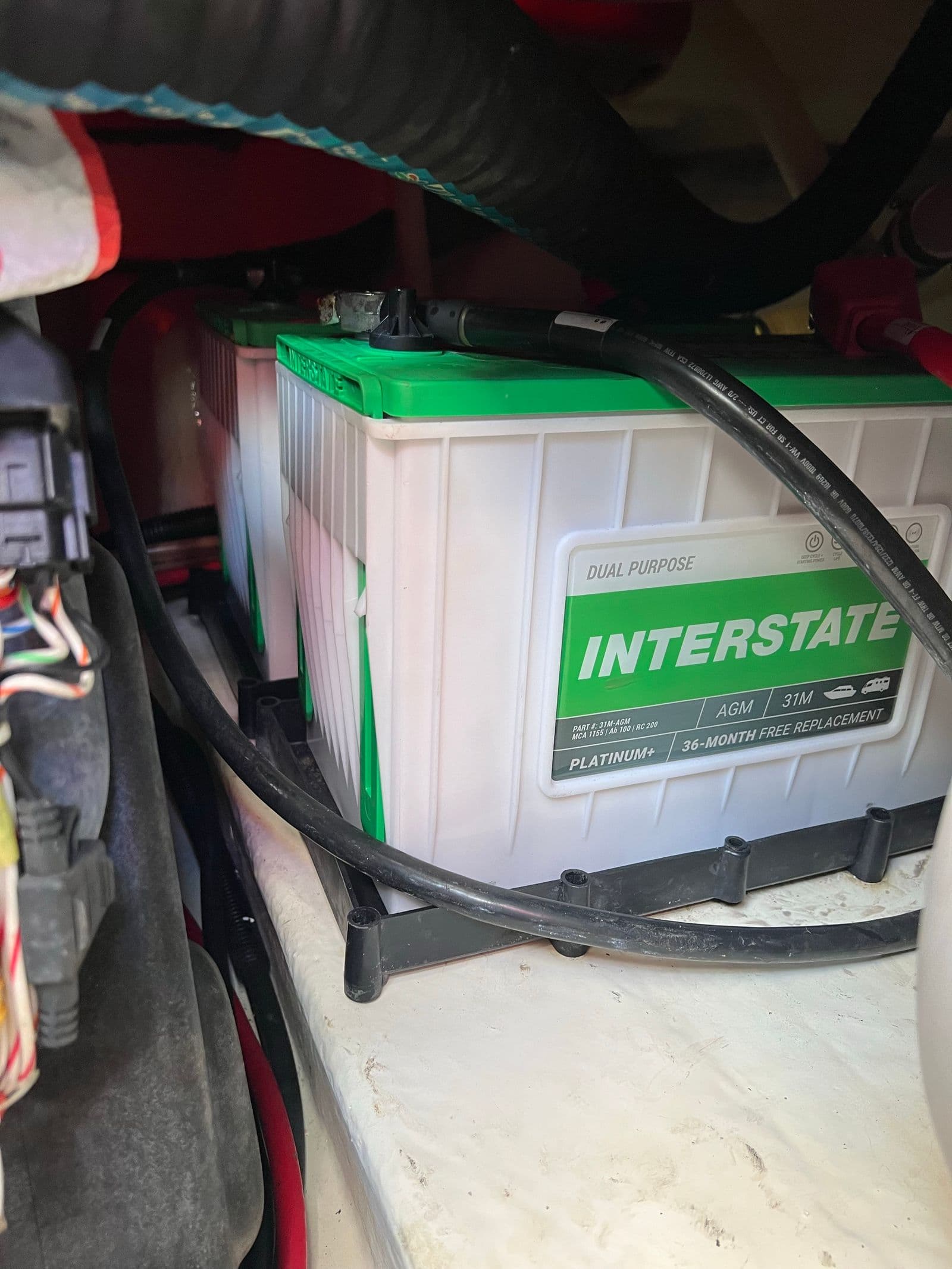New Interstate Group 31 AGM battery seated and connected, with 36-month free replacement label visible