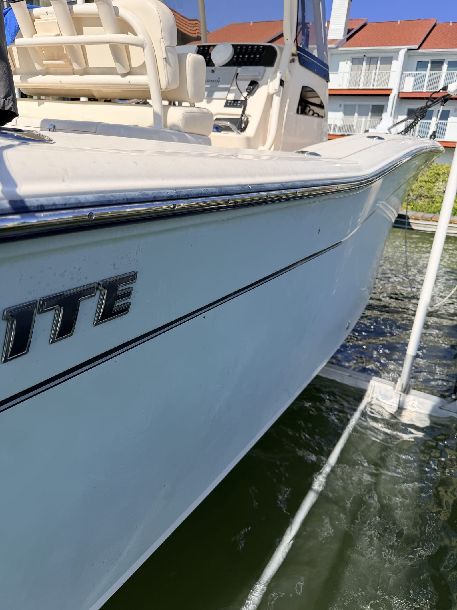Aging gelcoat on a Tampa Bay center console showing the dulling and surface oxidation that Florida UV and salt accelerate