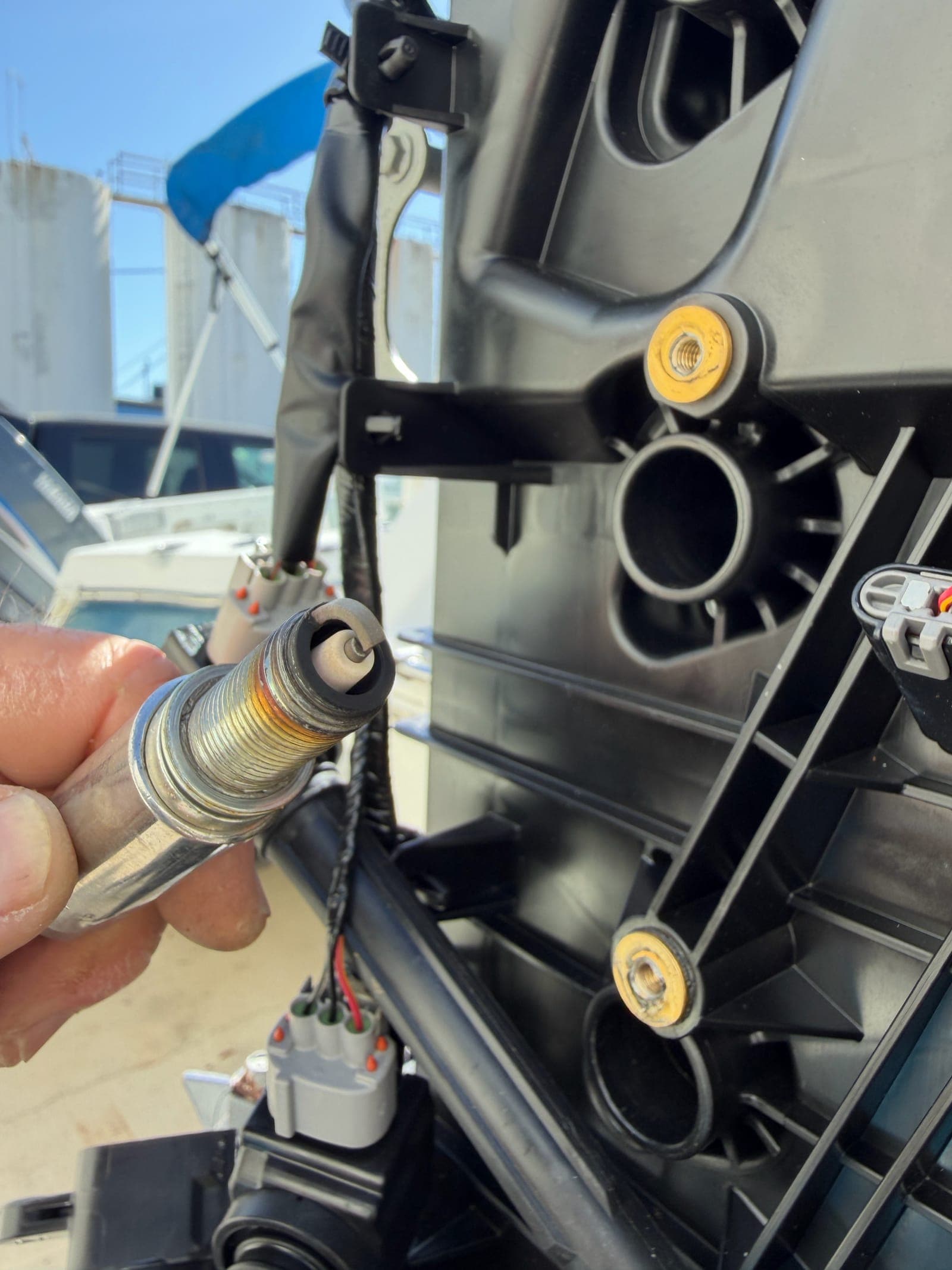 Mobile Marina technician pulling a spark plug from a Yamaha outboard during a line-by-line 300-hour service in Tampa Bay