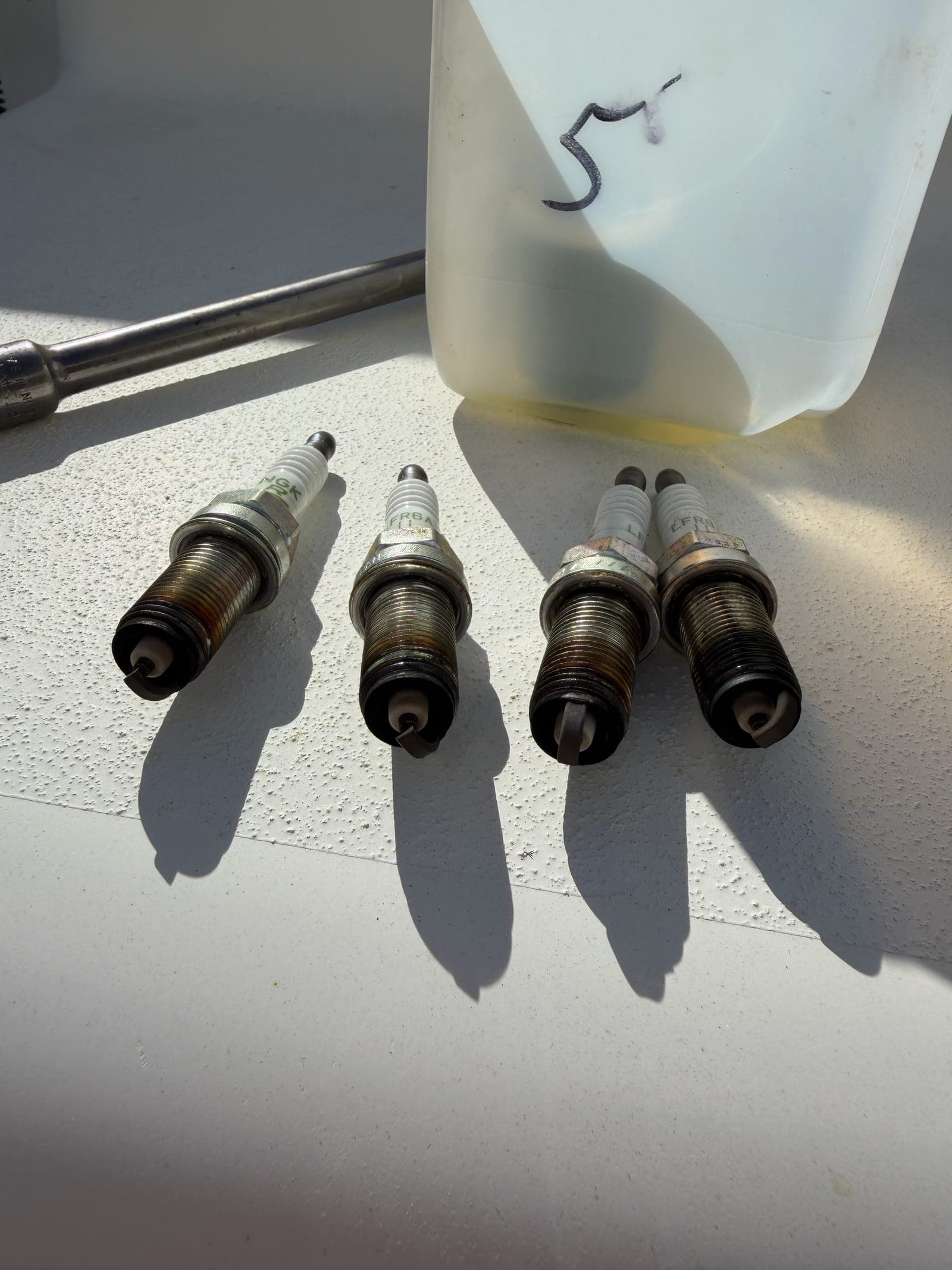 Spark plugs and Yamalube oil replaced during a 100-hour outboard service