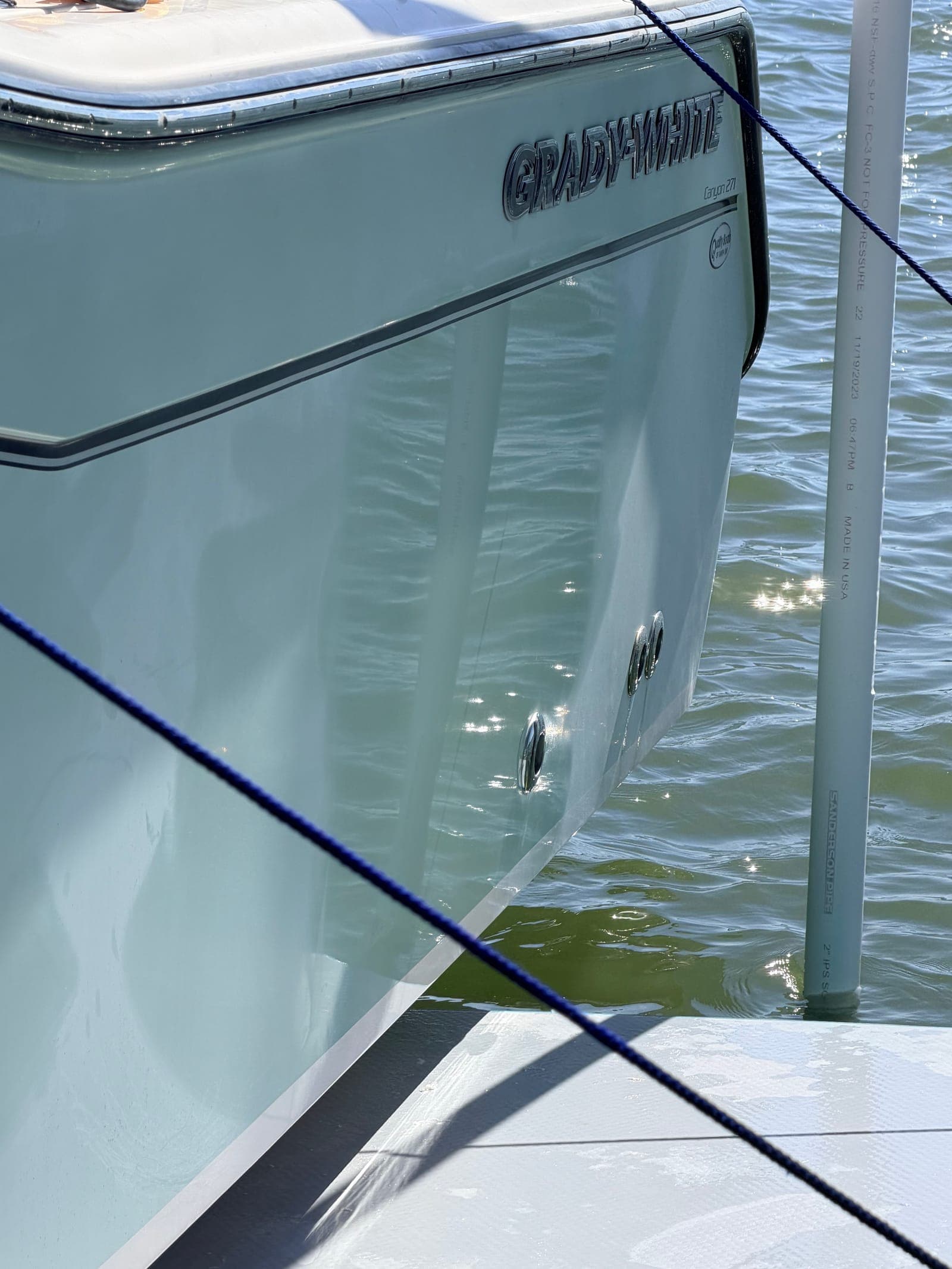 Close-up of a Grady-White hull with preserved gelcoat — what a documented monthly yacht management program keeps intact for resale
