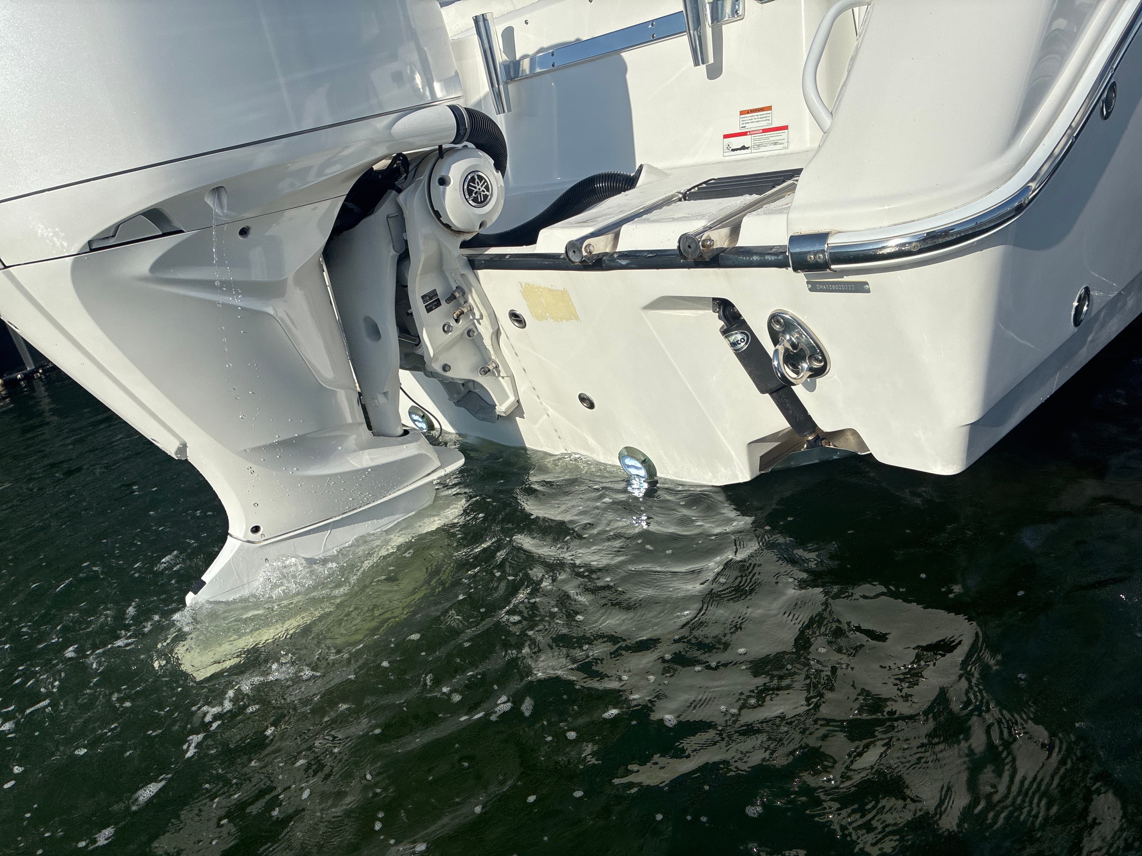 Stern and lower-unit area of a boat in Tampa Bay water